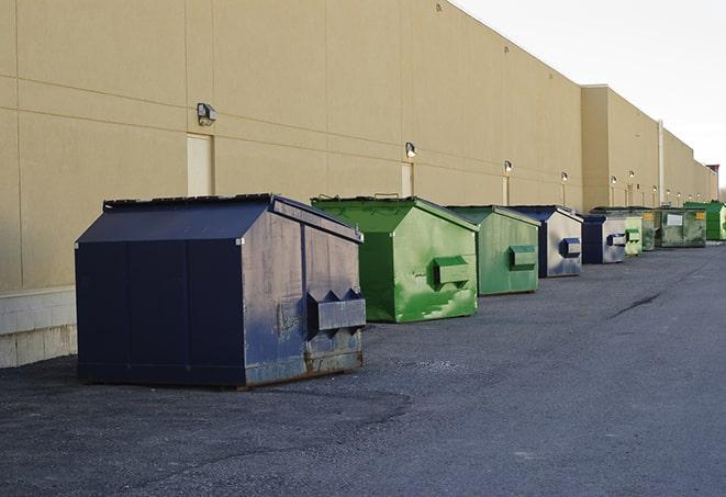 a row of industrial dumpsters at a construction site in Dunnellon